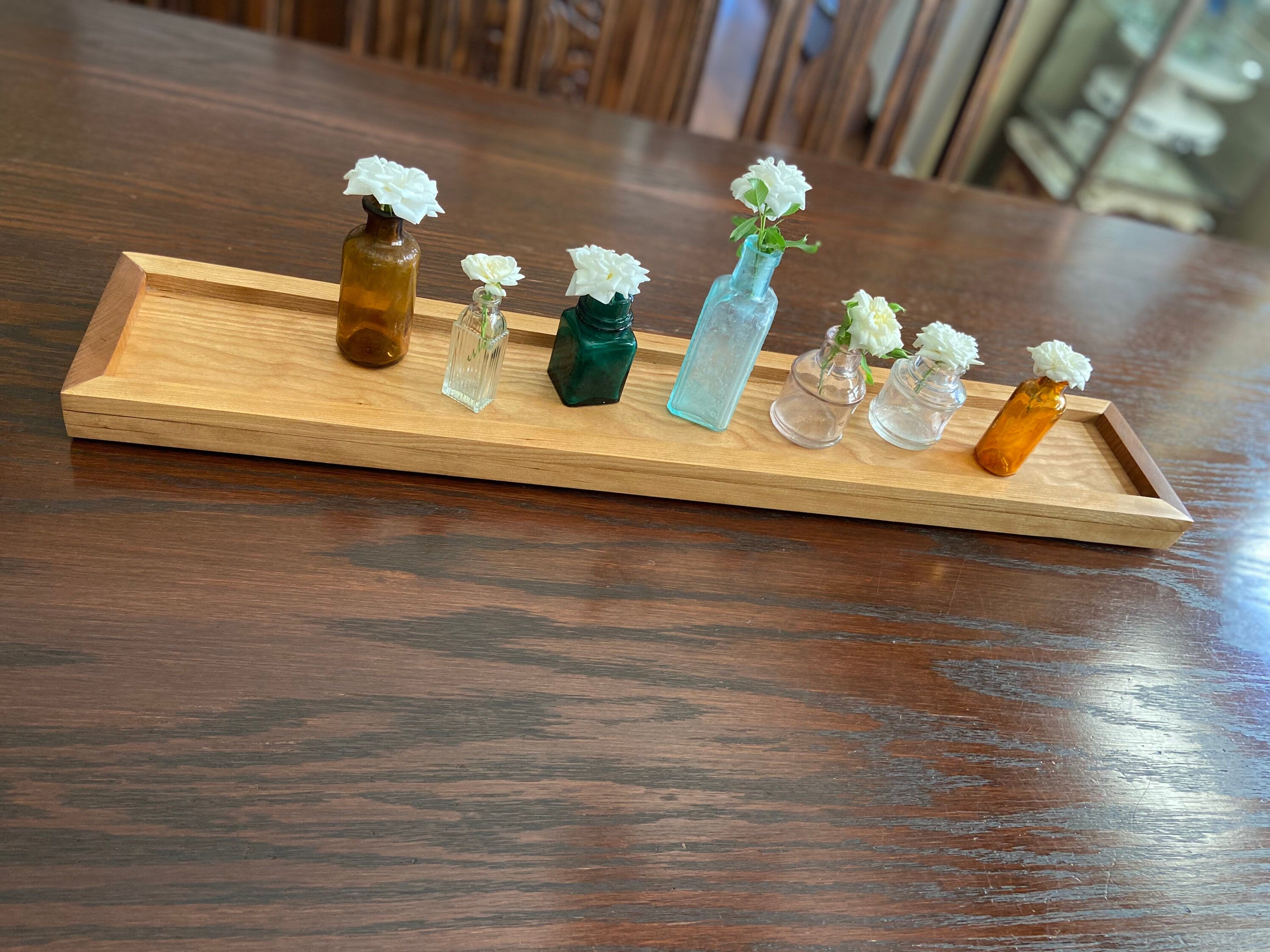 Cherry tray with miniature ink bottles for vases
