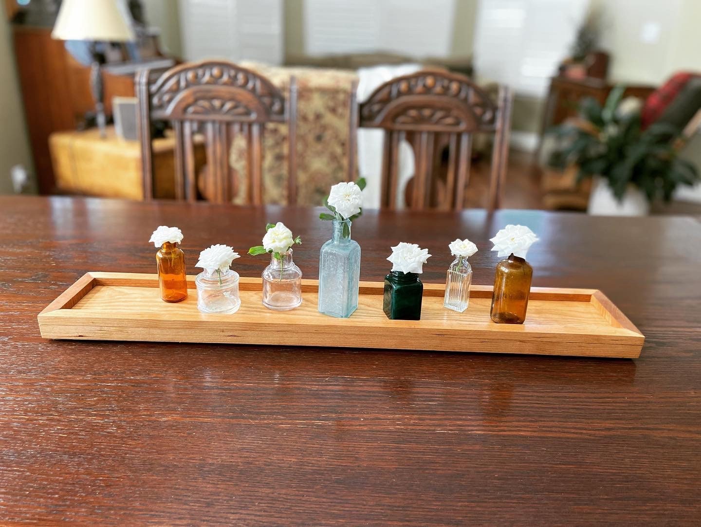 Cherry tray with miniature ink bottles for vases