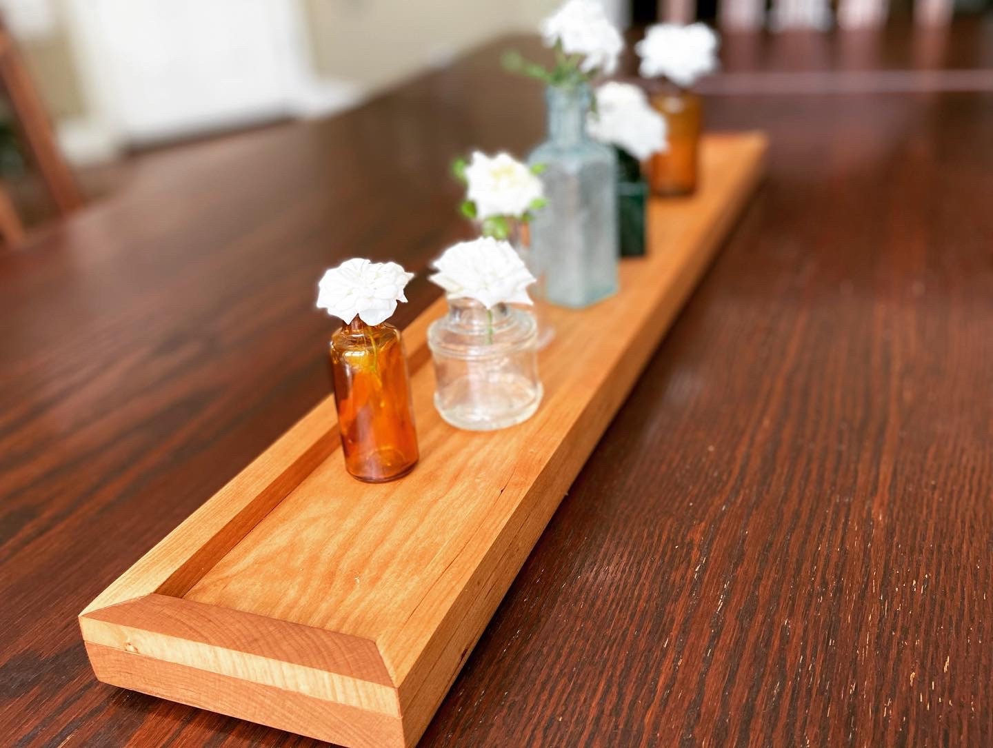 Cherry tray with miniature ink bottles for vases